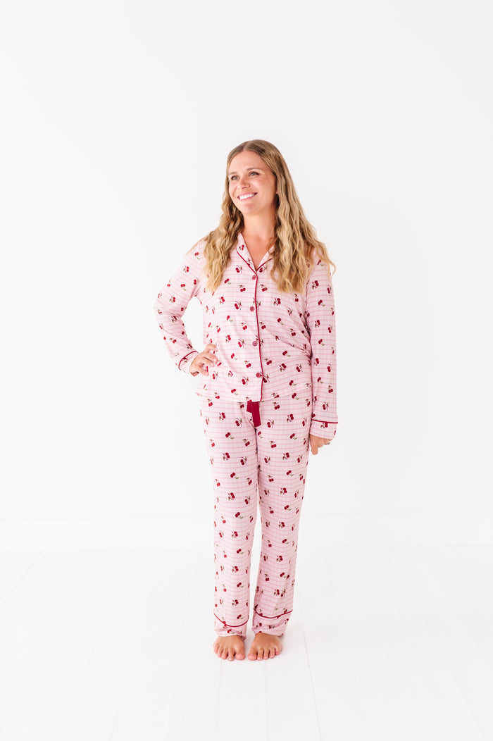 Woman wearing a pink pajama set with a white background