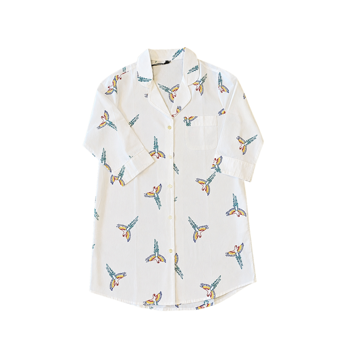 White shirt with colorful butterfly pattern on a white background. Size large crisp white cotton long-sleeve pajama shirt featuring artisan hand-stitched tropical parrot details.